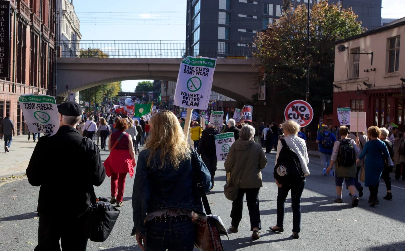 a group of people on the street holding signs