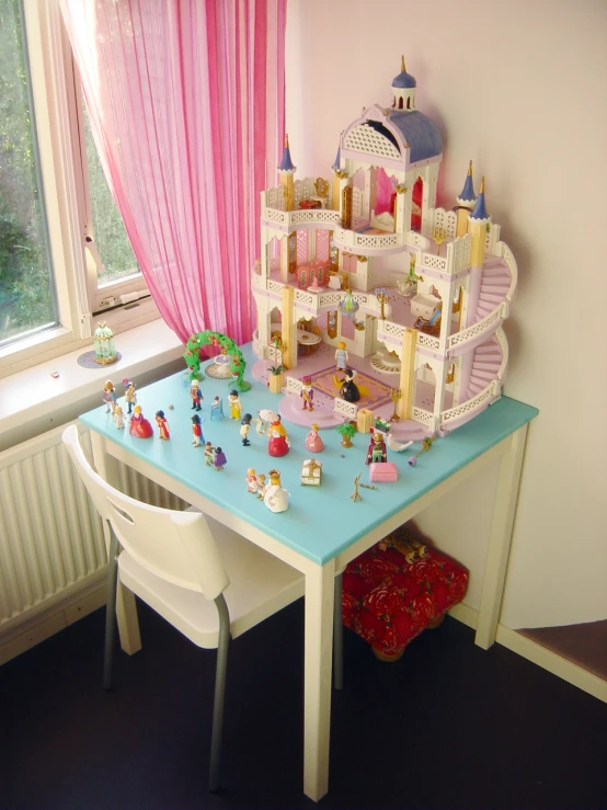 a girl's room with a table filled with small toys