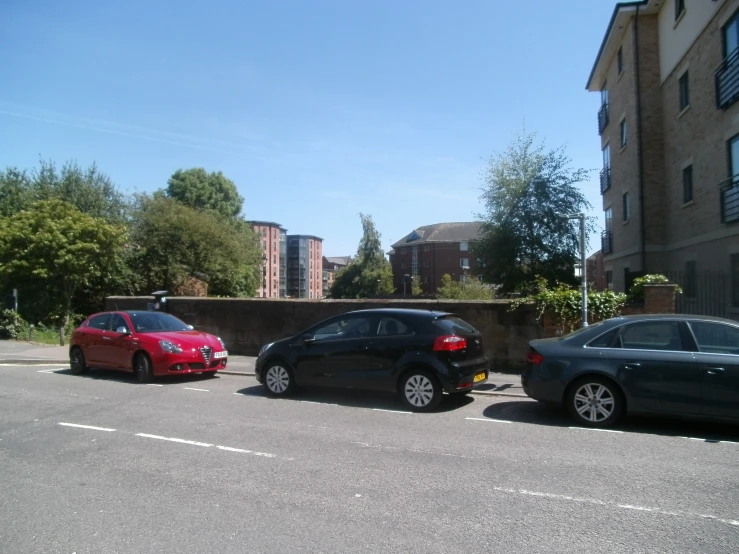 two vehicles parked near a wall in the city