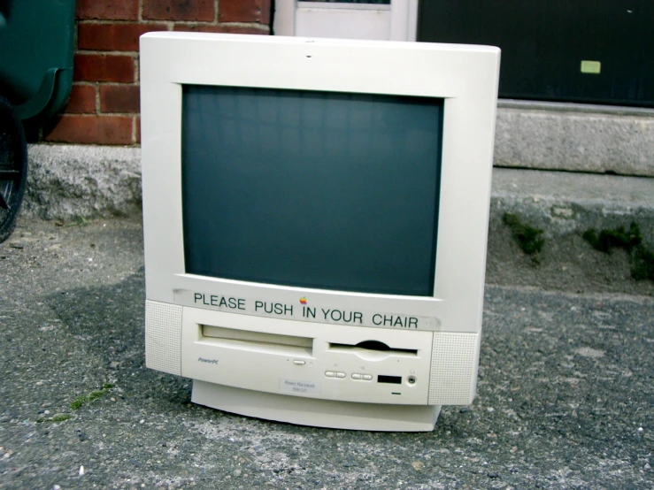 a desktop computer sitting on top of the sidewalk