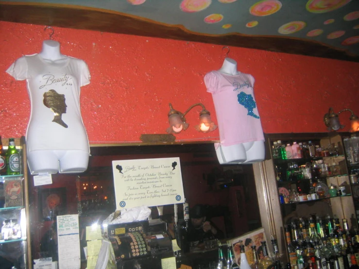 a bar with many shirts hanging on the wall