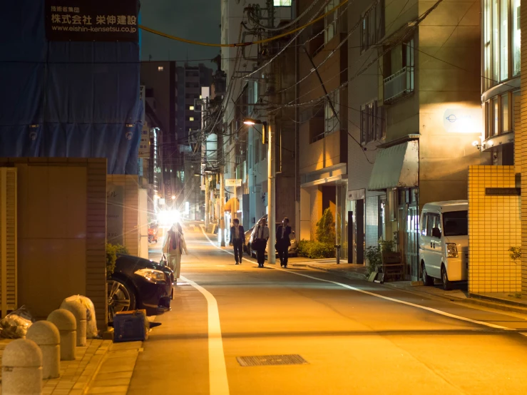 a couple walking down the road in the dark