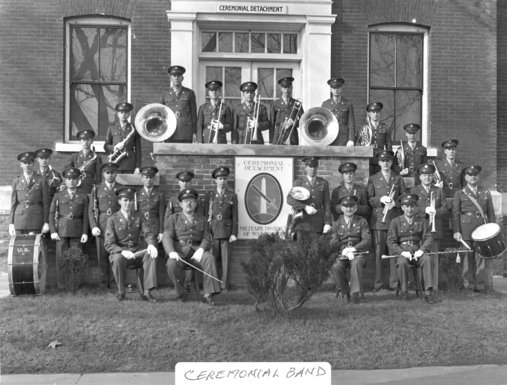 a group of men and women in uniform posing on the steps with marching gear