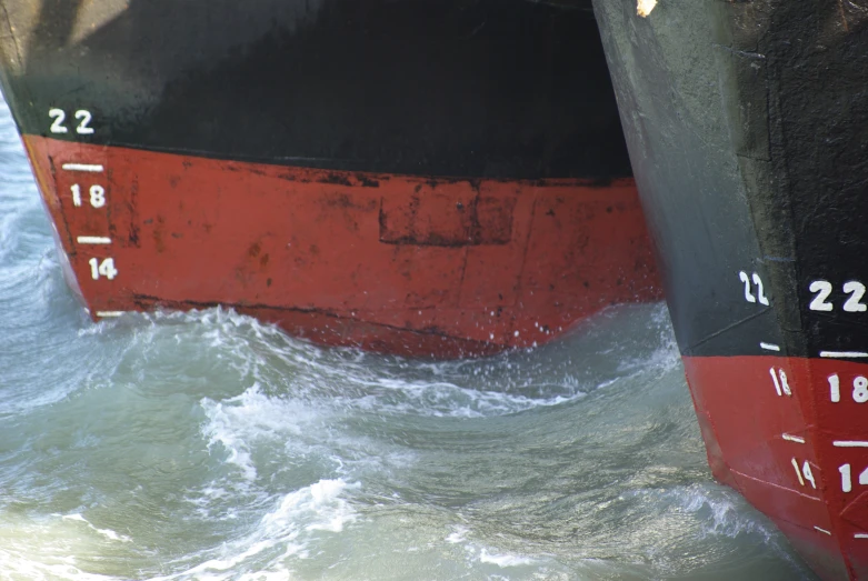 two large ships in the ocean are near each other