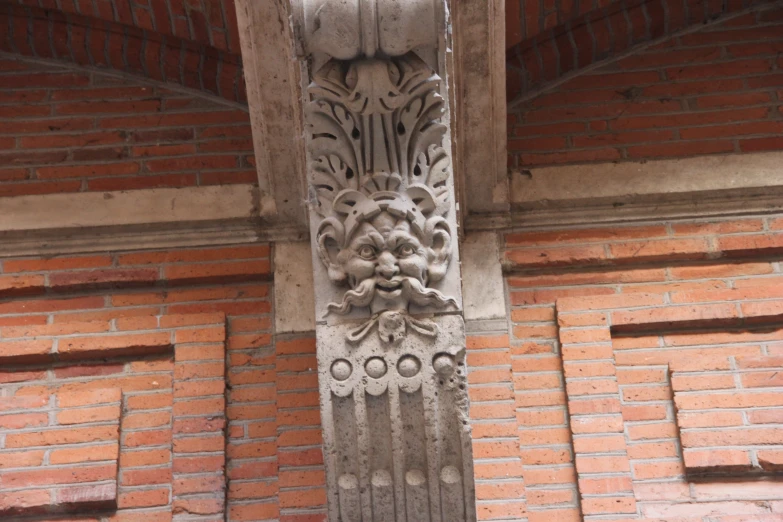 a clock is mounted on the side of a brick building