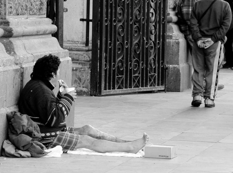 a woman sitting on the ground using her phone