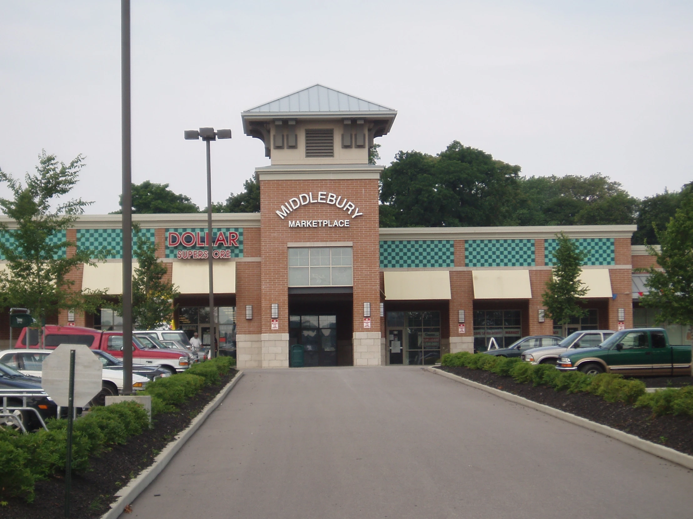 the front of a store with cars parked in front