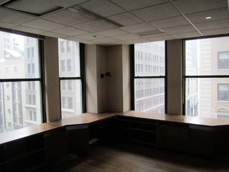 an empty office space with three counters and windows