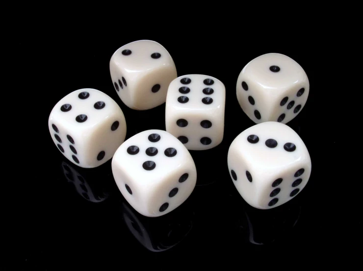 seven white and black dice with black dots on the sides
