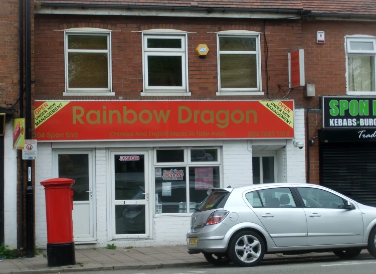 a white car parked in front of a store