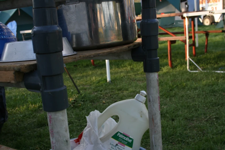 a trash can that is sitting in the grass