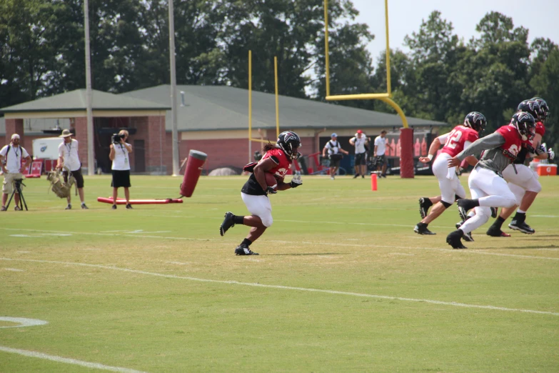 football player runs for the end zone on the field