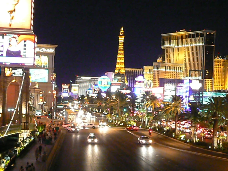 a city street with neon lights at night