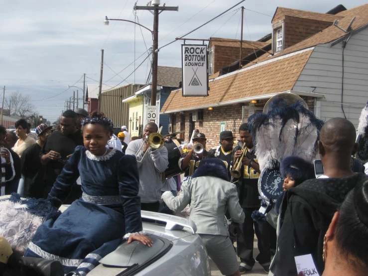 a group of people standing around each other on a street