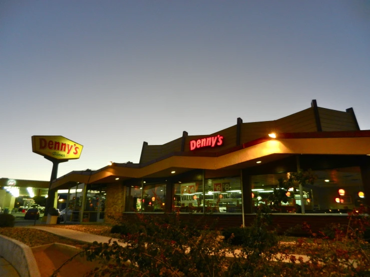 an outside view of a restaurant with several chairs and tables