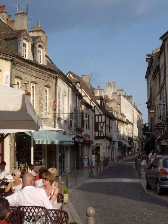 a street with lots of people eating and drinking