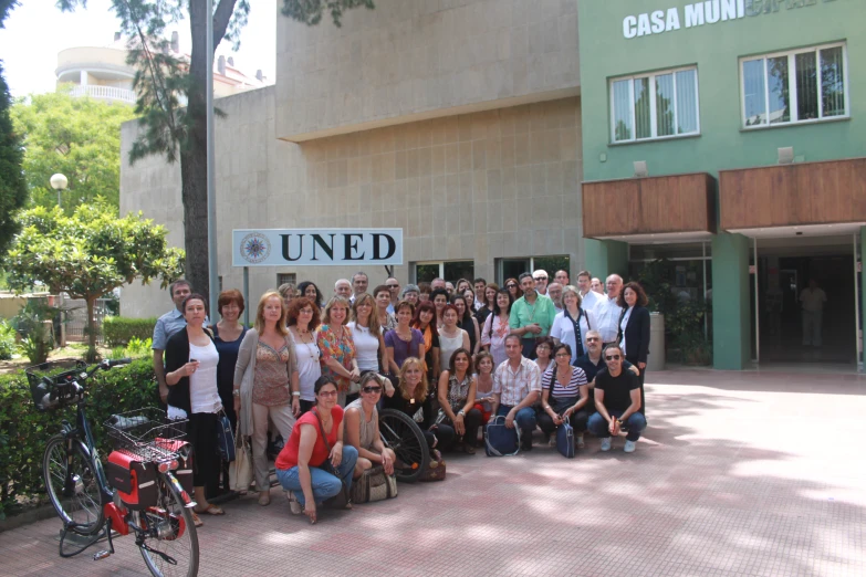 several people standing and sitting outside a building