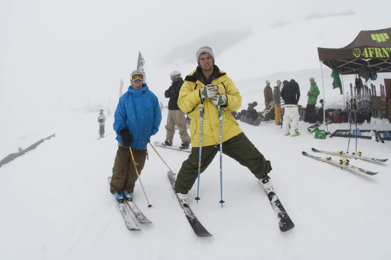 two men on skis on a snowy slope