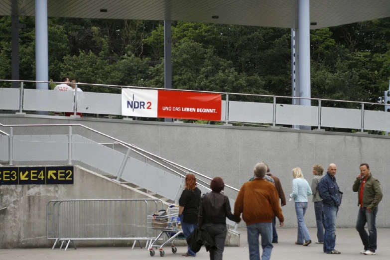 people walk up stairs at an airport and sign that reads nor2