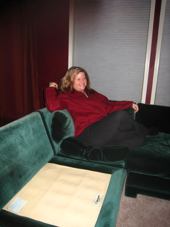 woman sitting on couch, looking to one side of the couch