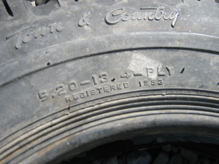 the side view of a large tire with some words and lettering on it