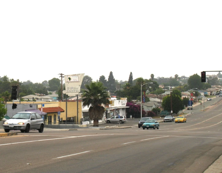 a stoplight hanging over a city street filled with traffic