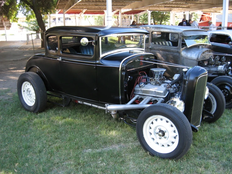 old time style classic vehicles parked on some grass