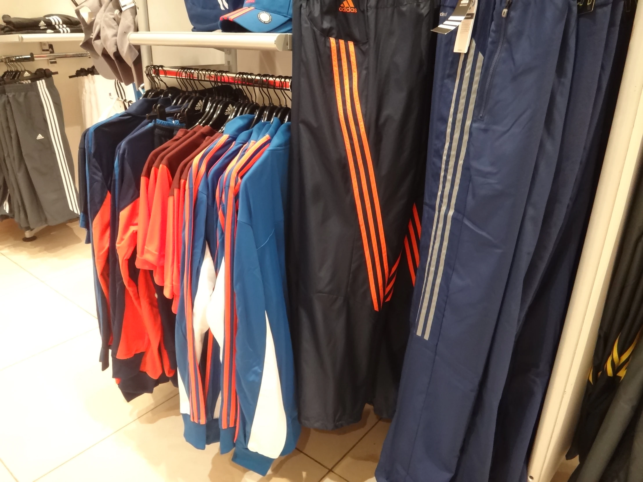 many soccer pants on hangers in a store