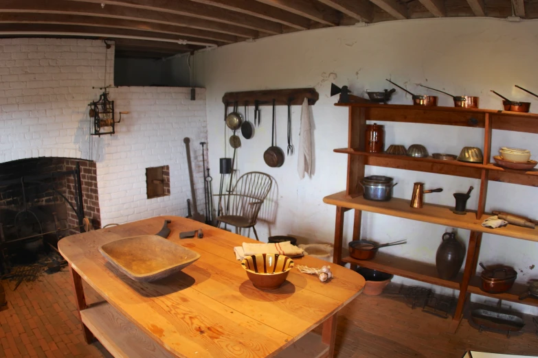 there is an old fashioned kitchen with two wooden bowls on the table