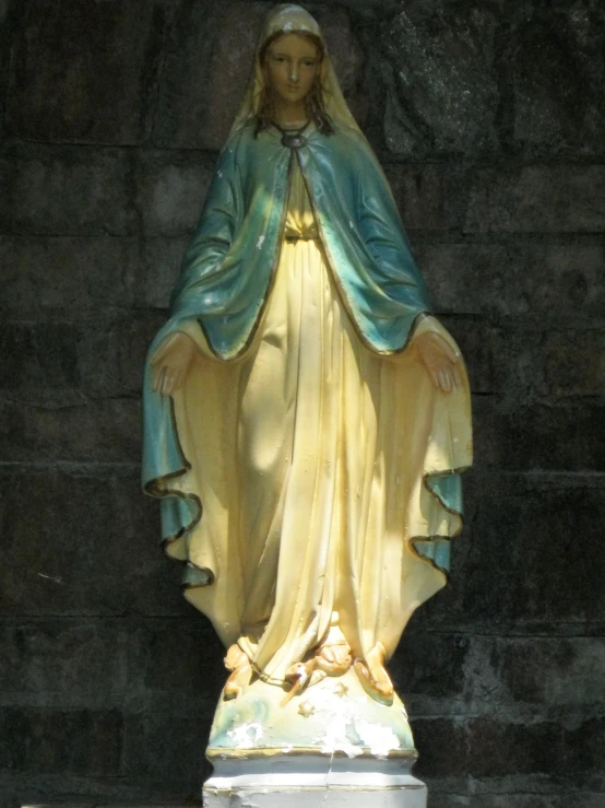 a statue of mary holding the hands of jesus