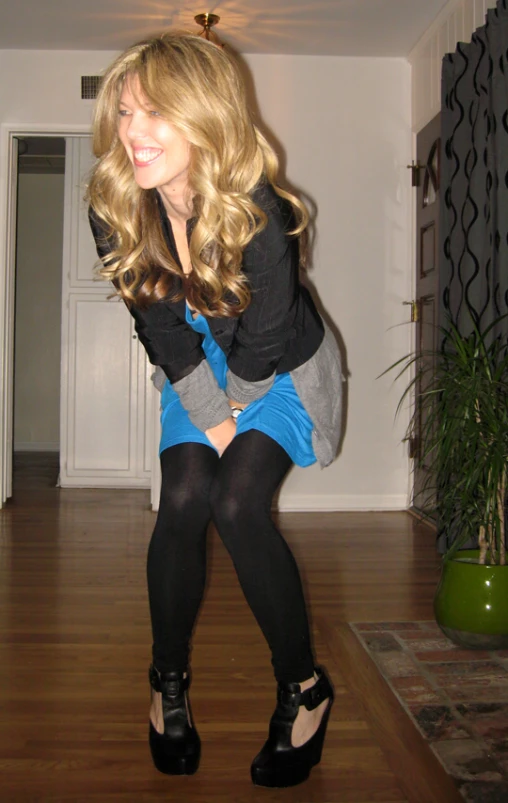 a young woman standing on top of a wooden floor