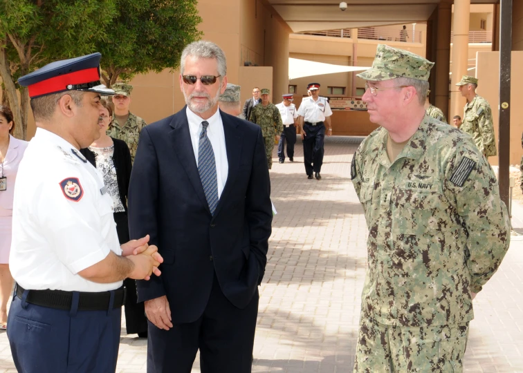 a couple of men in military attire standing near each other