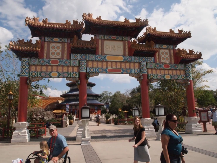 three women with a bike under a chinese gate