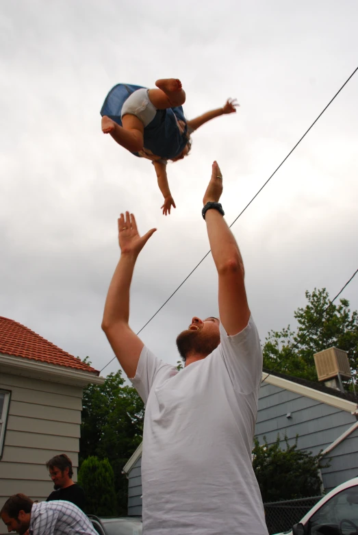 a man balancing on the back of a child