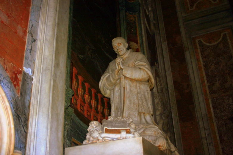 a statue of a monk next to a door