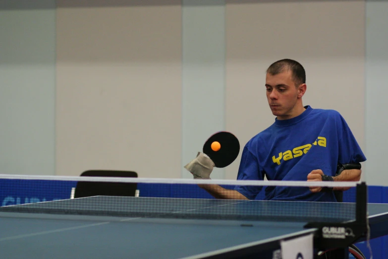 a man holding a tennis racket prepares to serve