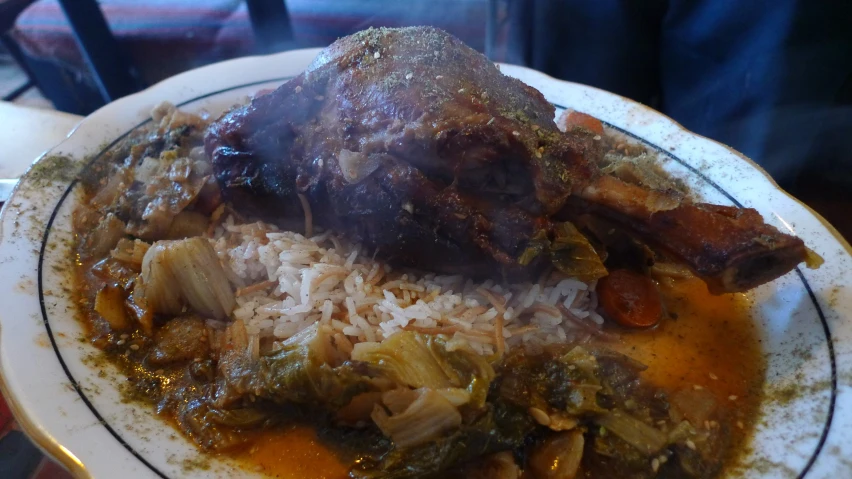 an exotic meal with pork and greens served with rice