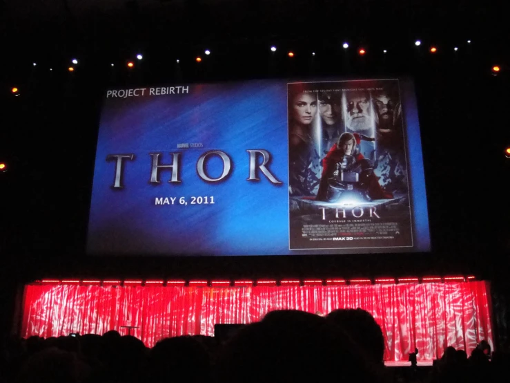 a big poster with a thor movie coming out of it