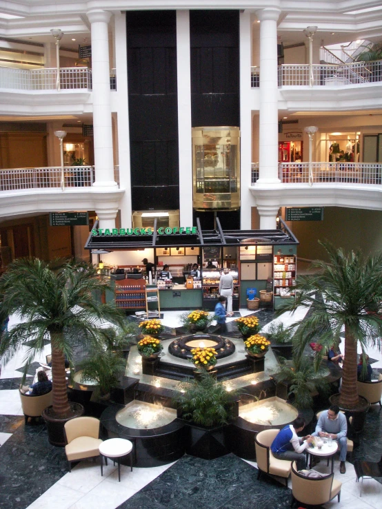 an image of a mall lobby with lots of plants