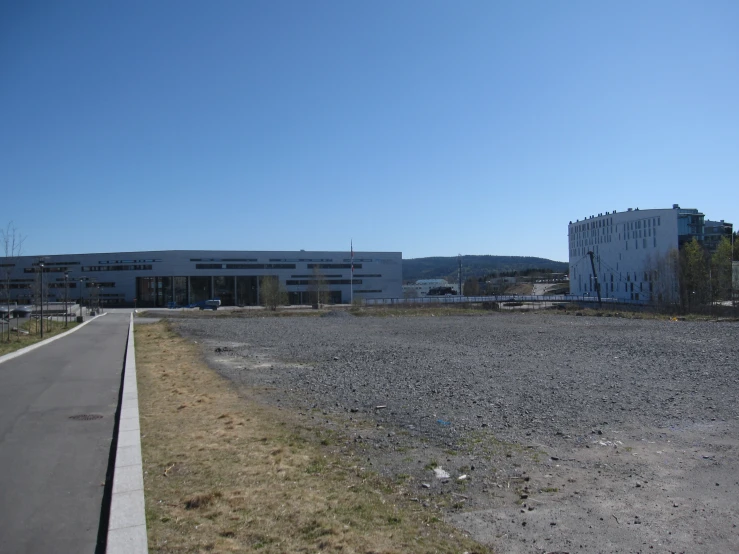 there is a road going to some buildings on the side