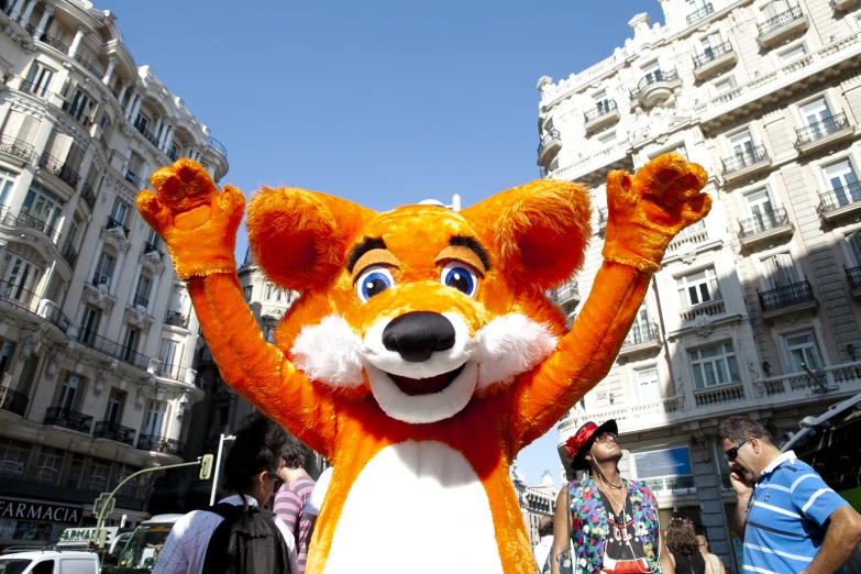 a orange bear costume in a city square