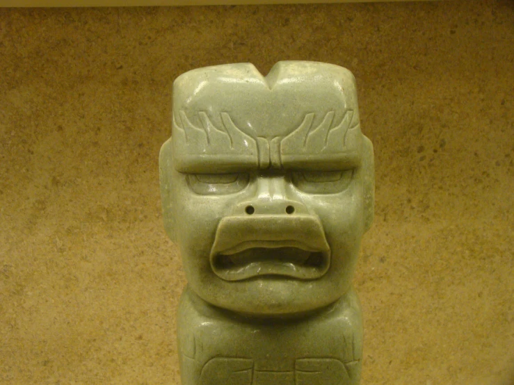 a ceramic statue with an angry looking look on it's face