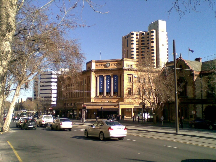 a busy city street and an old building and skyscrs