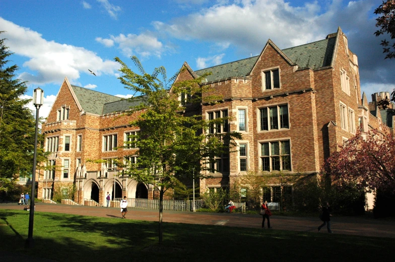 some people are walking towards a very large building