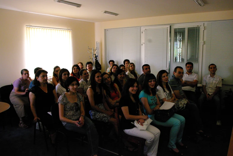 group of people sitting in a room together