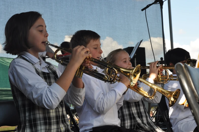 some children playing musical instruments in uniform