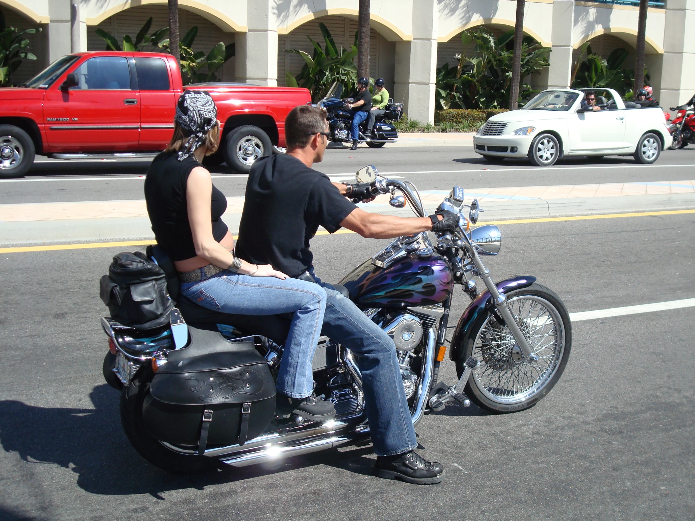 the man and woman are on their motorcycle