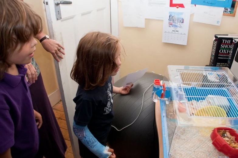 two little girls are playing in a play room