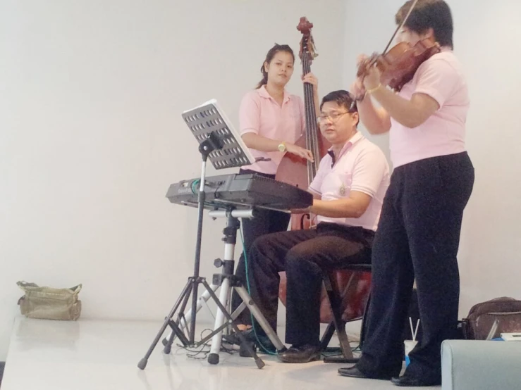 the music staff is playing their instruments near a woman