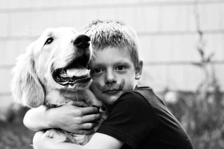 a black and white image of a boy with a dog